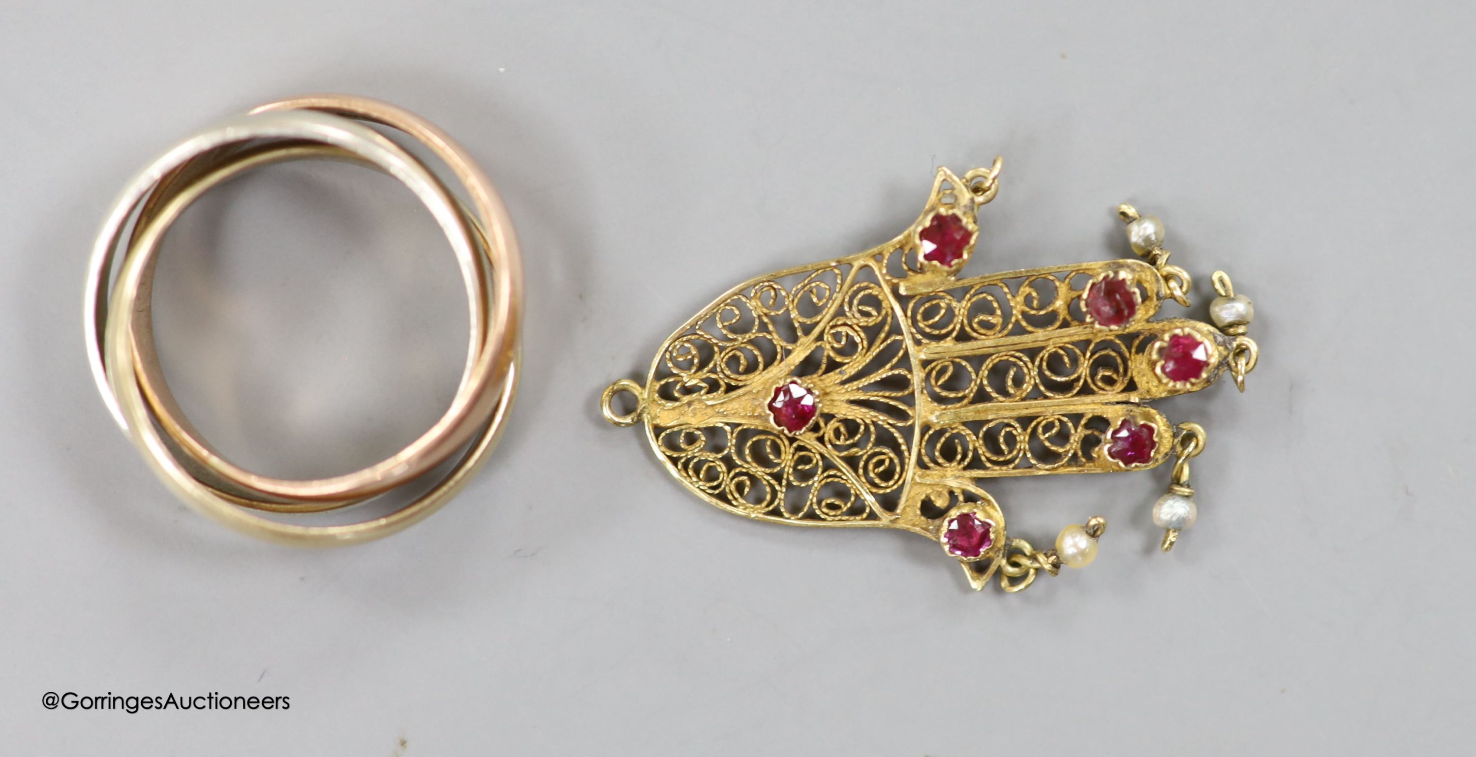 A 9ct three-colour gold puzzle ring, a Victorian yellow metal, 4.8 grams, rose diamond and onyx mourning brooch and four other items